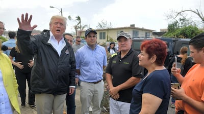 US president Donald Trump and his wife, Melania, visit residents affected by Hurricane Maria in Guaynabo, west of San Juan, in Puerto Rico on October 3, 2017. Mandel Ngan / AFP