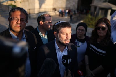 Bezalel Smotrich speaks to a journalist outside the Damascus Gate in Jerusalem as fellow far-right politician Itamar Ben Gvir, left, looks on. AFP