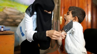 A boy receives a vaccination for measles and rubella at school in February 2019, during an immunization campaign in Sanaa, Yemen. Reuters, file