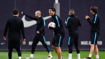 Luis Suarez jokes with Lionel Messi. David Ramos / Getty Images