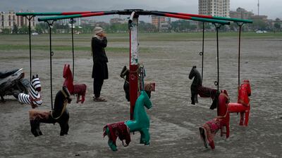 A merry-go-round sits unused as rain falls on Kabul. AP