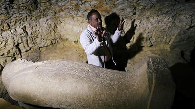 Egyptian antiquities worker gestures near a coffin inside the recently discovered burial site in Minya, Egypt. Mohamed Abd El Ghany / Reuters