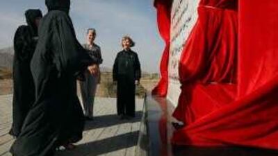 Lesley Botten, of Kinross, Scotland, centre left, and her mother, June, right, meet a group of women from Fujairah municipality during the dedication of a memorial to June's uncle, Sgt William Donnelly.