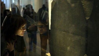 A visitor at the British Museum in London inspects the Rosetta Stone. Brian Harris / Rex Features