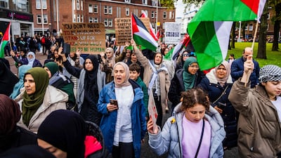 Demonstrators hold Palestinian flags and placards during a rally in The Hague, the Netherlands. AFP