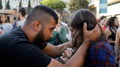A protester calms another who was overwhelmed with tears in Beirut. AP Photo