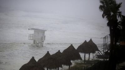 Waves surge onto shore past a lifeguard stand in Panama City Beach. Bloomberg