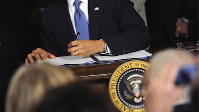 US presidents Obama, George W Bush, his father George H and Bill Clinton were all left-handed. Shawn Thew / EPA