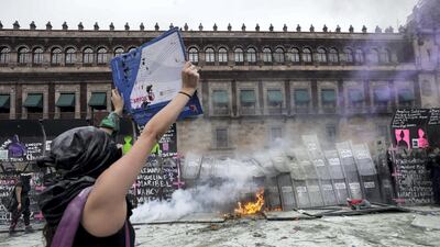 A woman holds a placard during a protest outside the National Palace on International Women's Day in Mexico City, Mexico. Reuters