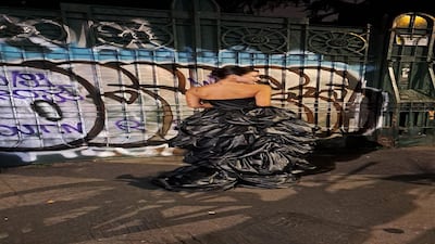 A dress made with swags of black shiny fabric