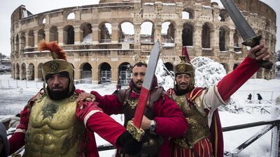Men posing as a centurions in front of the Colosseum covered by snow during a snowfall in Rome. Angelo Carconi / EPA