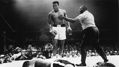 Muhammad Ali stands over a prone Sonny Liston during their second fight that took place in 1965. Ali won via a first-round knockout. Getty