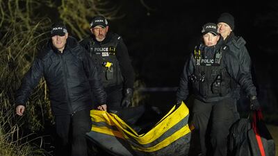 Police at Babbs Mill Park in Kingshurst, Solihull, where the children were pulled from the frozen lake. PA