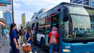 Commuters catch the bus to work in central Abu Dhabi