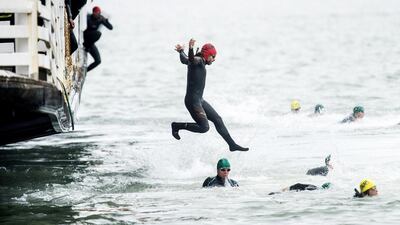 A swimmer jumps from the San Francisco Belle at the start of the 34th annual Escape from Alcatraz Triathlon in San Francisco, California, on Sunday. Participants swim 1.5 miles (2.4 km) to shore, bike 18 miles (30 km) and finish with an 8 mile (13 km) run. Noah Berger / Reuters / June 1, 2014