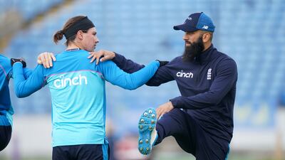 England's Rory Burns, left, and Moeen Ali during a nets session. PA