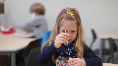 A student from Fritz Karsen Community School takes a Covid-19 test before classes begin in Berlin, Germany. AP Photo