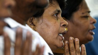 Sri Lankan Catholic devotees pray during a mass at the St. Theresa's church as the Catholic churches hold services again after the Easter attacks in Colombo on May 12, 2019. Thousands of Catholics attended mass in Sri Lanka's capital Colombo on May 12 amid tight security to prevent a repeat of Easter bomb attacks that killed 258 people. / AFP / LAKRUWAN WANNIARACHCHI