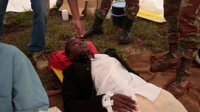 A rescued woman lies in a makeshift clinic for medical attention in Chimanimani. EPA