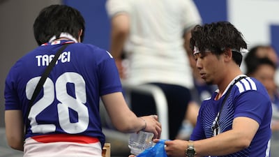 Japan fans clean up after their World Cup Group F match against the Netherlands at the Dallas Stadium in Arlington, Texas. AFP