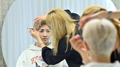 Blitzers member Lee Jun-young having his make-up done at a beauty salon in Seoul ahead of a promotional shoot. AFP