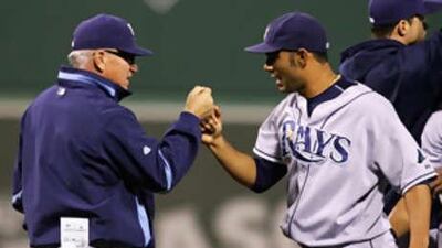The Tampa Bay Rays manager Joe Maddon celebrates with Carlos Pena.