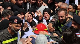 Mourners at a funeral procession for Lebanese Civil Defence workers Hussein Jaber and Ahmad Noura, killed in a direct Israeli strike. EPA