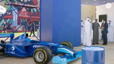 Sheikh Khaled views a vehicle at the remodelled Yas Marina Circuit before the races.