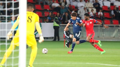 Japan's Junya Ito, left, fights for the ball with Oman's Ahmed Faraj Abdulla Rawahi. AFP