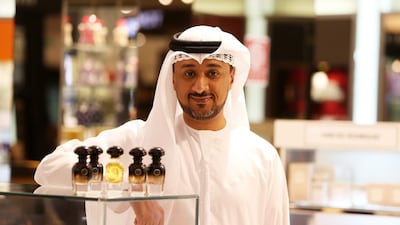 Ali Al Jabari, founder of the perfume brand AJ Arabia, with the Black and Gold versions of perfume bottles at Harvey Nichols store at Mall of the Emirates. Pawan Singh / The National
