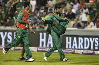 Shoaib Malik carries Babar Azam off injured during the T20 international against England at Old Trafford on September 7, 2016. Getty Images