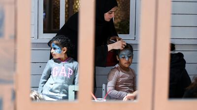 A young girl gets her face painted at the Winter Wonderland event on the Maryah Island waterfront promenade.