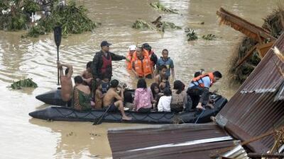 Police rescue trapped residents following a flash flood that inundated Cagayan de Oro city today.