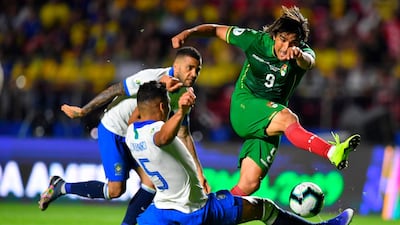 Bolivia's Marcelo Martins, right, sees a shot blocked by Brazil midfielder Casemiro. AFP