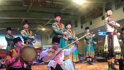 Uighur folk dancers perform at a food court in Hotan.