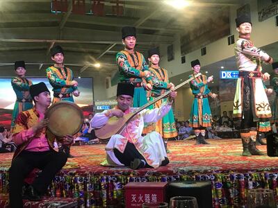 Uyghur folk dancers perform at a food court in Hotan, Xinjiang