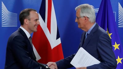 Britain's Brexit secretary Dominic Raab and the EU's chief Brexit negotiator Michel Barnier shake hands in Brussels. Reuters
