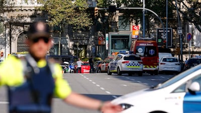 A policemen blocks the street to a cordoned-off area in central Barcelona. Pau Barrena / AFP.