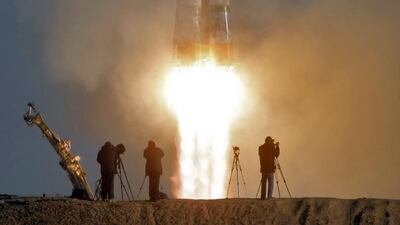 Cameramen film as the Soyuz-FG rocket booster with Soyuz TMA-11M space ship carrying new crew to the International Space Station, ISS, blasts off at the Russian leased Baikonur cosmodrome in Kazakhstan. Dmitry Lovetsky / AP
