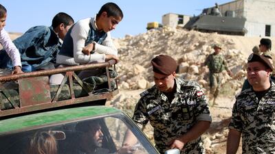 Lebanese security forces check identity and papers of Syrian refugees getting ready to cross into Syria from the eastern Lebanese border town of Arsal, on June 28, 2018. Stringer / AFP
