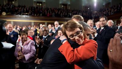 Mr Obama hugs Gabby Giffords as he arrives to deliver the State of the Union address in the House Chamber on January 24, 2012 at the US Capitol in Washington. Photo courtesy of the National Archives