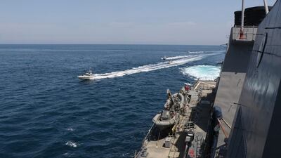 In this Wednesday, April 15, 2020, photo made available by the US Navy, Iranian Revolutionary Guard vessels sail close to US ships in the Arabian Gulf near Kuwait. All Photos supplied by US Navy
