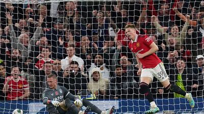 Manchester United's Scott McTominay, right, celebrates scoring their side's fourth goal during the Carabao Cup, third round match at Old Trafford, Manchester. PA
