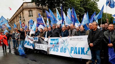 Members of French police union Alliance Police Nationale sing the national anthem in front of the Elysee Palace during a protest against the French Interior Minister's latests announcements. AFP / Thomas SAMSON