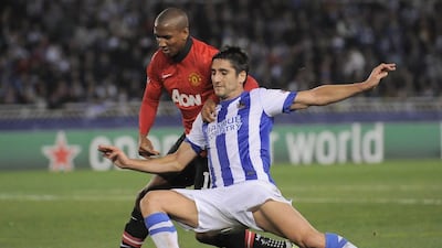 Manchester United's Ashley Young, back, duels for the ball with Real Sociedad's Markel Bergara during their Champions League Group A match at Anoeta stadium in San Sebastian, northern Spain, on Tuesday. Alvaro Barrientos / AP Photo