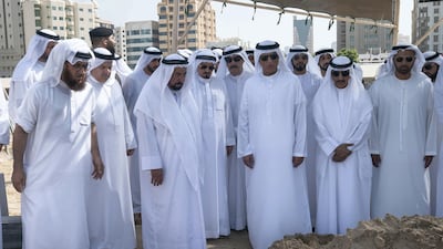 Sheikh Dr Sultan bin Muhammad, Ruler of Sharjah, Sheikh Humaid bin Rashid, Ruler of Ajman, Sheikh Saud bin Saqr, Ruler of Ras Al Khaimah and other sheikhs stand over the grave of Sheikh Khalid during his burial on Wednesday. Wam