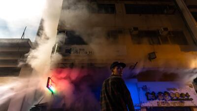 A man react as firefighters work to put out a blaze of a shop during a pro-democracy march at the Mongkok district in Hong Kong, China. Getty