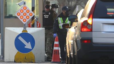 A US military policeman and South Korean security person check visitors at the US Army base Camp Walker, in Daegu, South Korea. Yonhap via AP