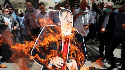Palestinian men burn a cardboard cutout of US Secretary of State Mike Pompeo during a protest against his visit to Israel in Nablus in the occupied West Bank. AFP