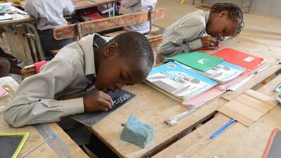 Mauri Bicesse, 1st grade, 9, rights down the amount used to buy a coffee as part of the schools bilingual programme. Naser Al Wasmi / The National
